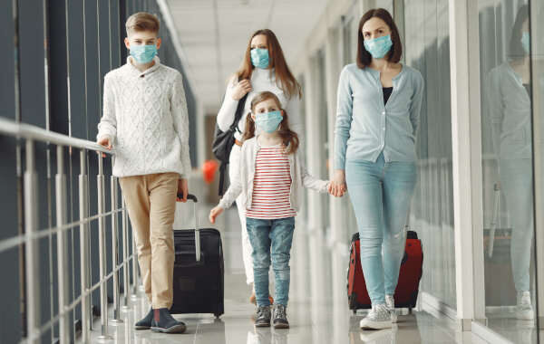 People in airport are wearing masks to protect themselves from v